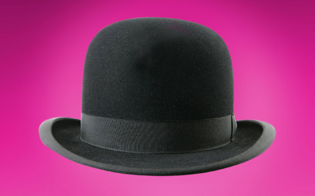 Black bowler hat on pink background