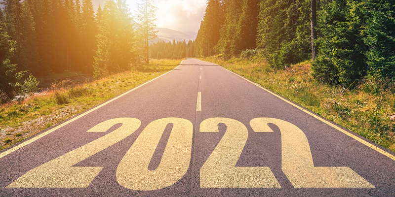 Empty asphalt road and New year 2022 concept. Driving on an empty road in the mountains to upcoming 2022. Concept for success and passing time.