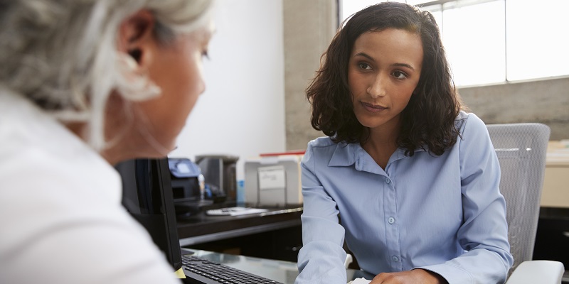 Concerned female analyst counselling senior patient