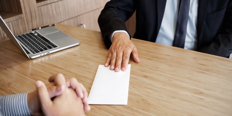 Businessman giving resign letter to his manager for quit a job.